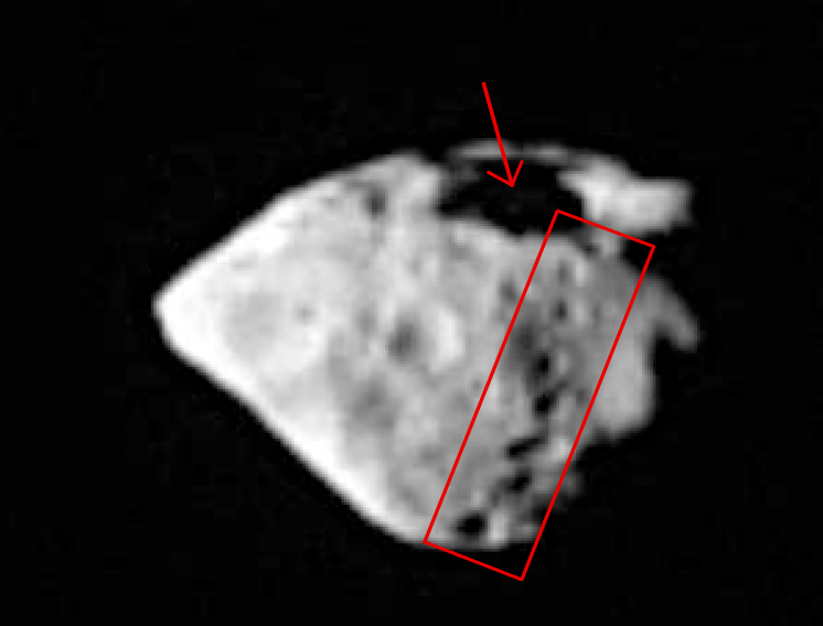 The large surface crater spanning about 2 km and the string of smaller craters lower down are the remnants of a very violent impact between Steins and another asteroid. Credits: OSIRIS/MPS/LAM/University of Padua.